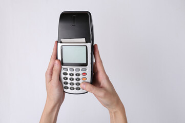 Hand holds payment terminal on white background. Payment for purchases