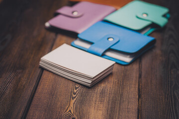 bright business card holders on a wooden background texture of a pack of white paper