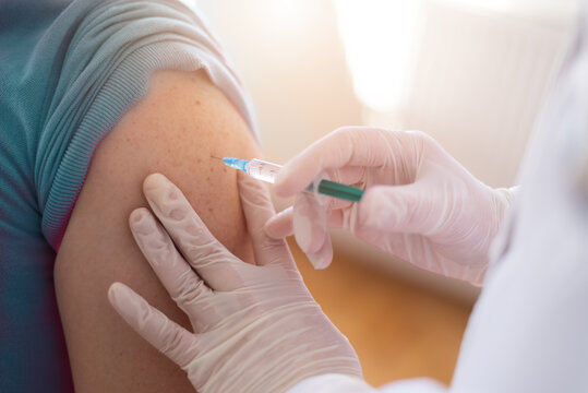 Covid vacine injection by doctor at hospital.Doctor making injection vaccination patient to prevent pandemic of the disease, flu or influenza virus in clinic