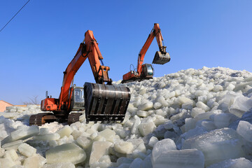 excavators pack ice on ice stacks in an ice cellar.