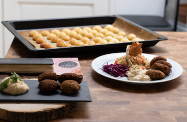 Home cooked arabian food plate, hummus with falafel, couscous and red cabbage