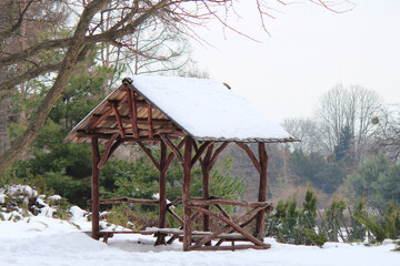 gazebo made of crooked logs in the botanical garden