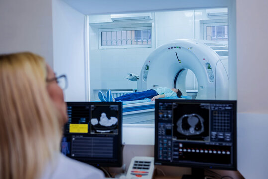 Radiologist in the control room of computed tomography at hospital