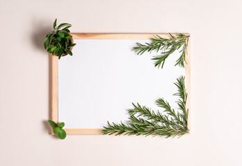 top view, white sheet of paper with rosemary branches and mint leafs and salvia