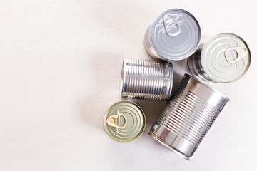 Various canned vegetables on kitchen table background.