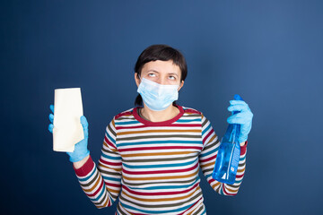 Tired housewife with disinfection equipment.