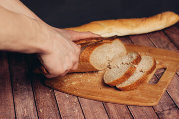 slicing a fresh loaf on a cutting board kitchen meal