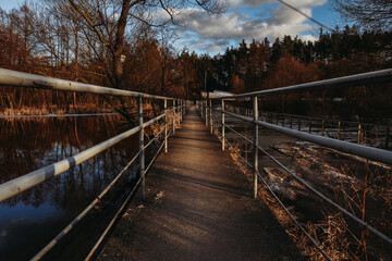 bridge in the forest in winter, golden hour 