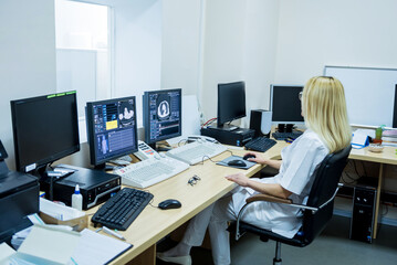 Radiologist in the control room of computed tomography at hospital