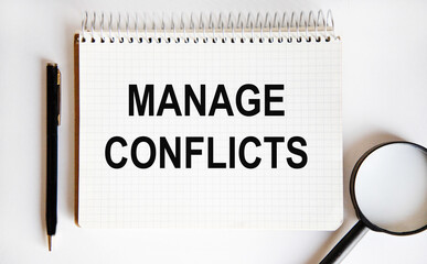 The text of MANAGE CONFLICTS, a pen and a magnifying glass are printed in the notebook.