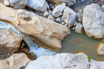 Scenic landscape with beautiful mountain brook. Idyllic scenery with clear water in small river. Fast water flow close-up