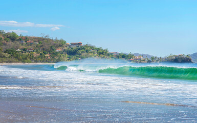 White Beach at Playa Flamingo with blue ocean and big waves. Guanacaste, Costa Rica, Central America.