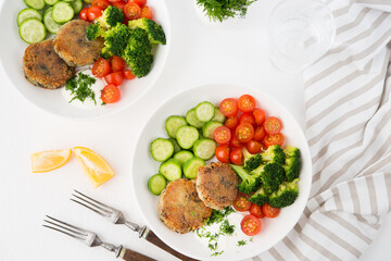 Vegetarian dish of potato patties with herbs and vegetables in a plate