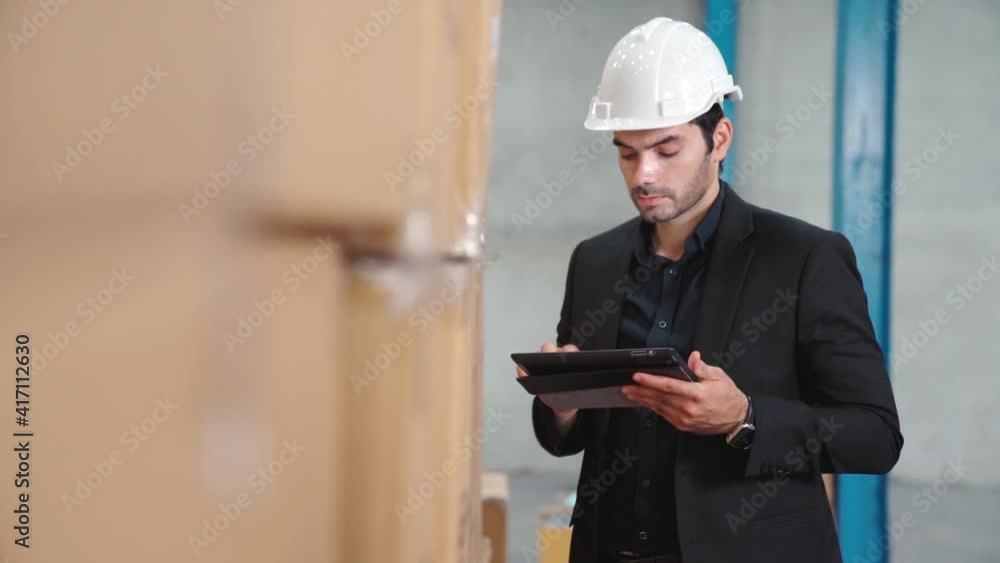 Poster factory manager using tablet computer in warehouse or factory . industry and supply chain management