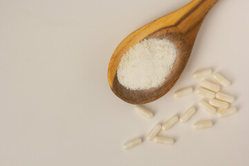 Closeup of myo-inositol powder and capsules.