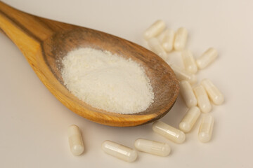 Closeup of myo-inositol powder and capsules.
