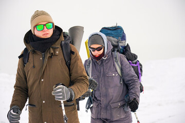 Fototapeta na wymiar Portrait of a guy in polarized glasses during a winter hike