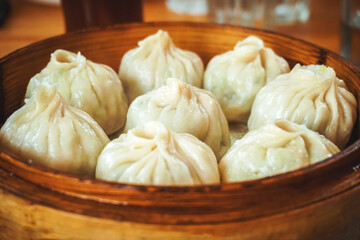 steamed dumplings in wooden basket