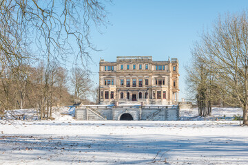 frozen river with a monumental building in the background