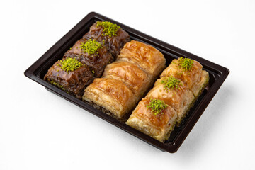 Turkish Ramadan Dessert Baklava from pistachios and walnuts. Selective focus. Isolated on white background.