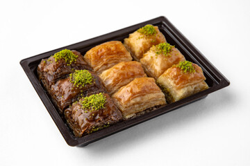 Turkish Ramadan Dessert Baklava from pistachios and walnuts. Selective focus. Isolated on white background.