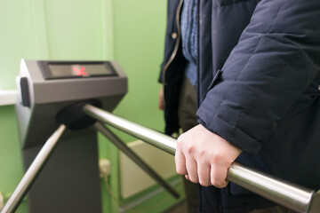 a person walks through the turnstile