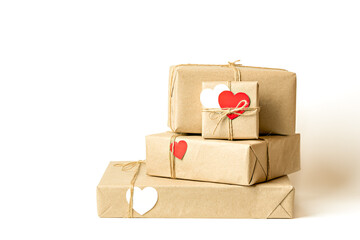 Obraz premium Gift boxes wrapped in recycled craft paper tied with twine on white background