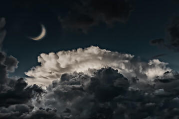 Crescent moon and clouds at night