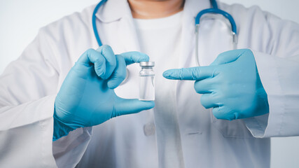 Doctor wear hand in blue gloves holding liquid vaccines,Concept fight against virus covid-19 corona virus