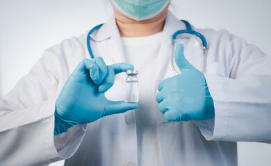 Doctor wear hand in blue gloves holding liquid vaccines,Concept fight against virus covid-19 corona virus