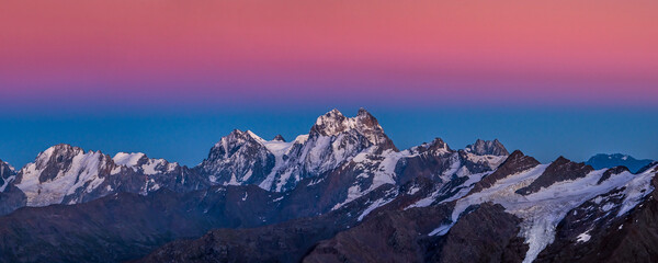 Snowy Greater Caucasus ridge with the Mt. Ushba after sunset. Panoramic view from 