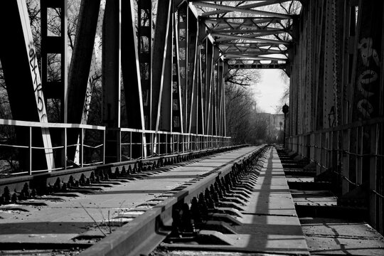 an abandoned railway bridge over a frozen river