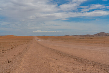 Landscape with road and a car at Namib-Naukluft National Park , s a national park of Namibia