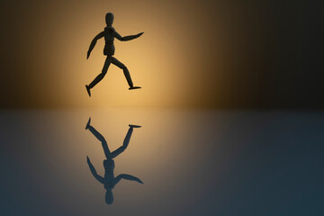 silhouette of wooden dummy running with reflection in the glass. concept of race to success. Space...