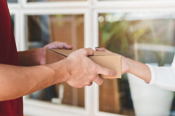 Delivery Man sending package to receiver on doorway.