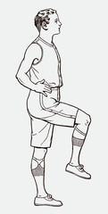 Young man from early 20th century in sportswear raising one leg and holding balance, in side view