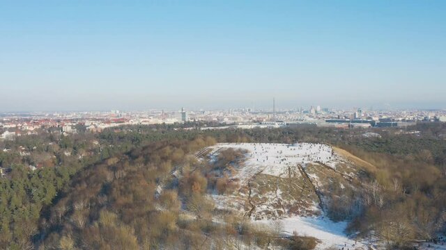people on top of snow covered drachenberg hill in berlin 