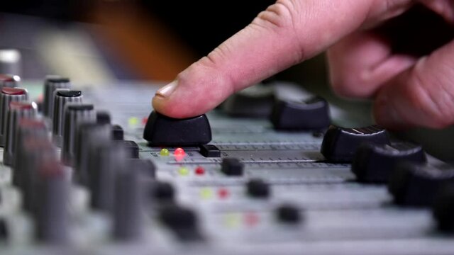 recording studio. setting up the sound mixer. turned on the microphone. A sound designer used a digital audio mixer in a production studio. Sound engineer connects equipment