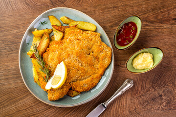 schnitzel with chips on a blue plate