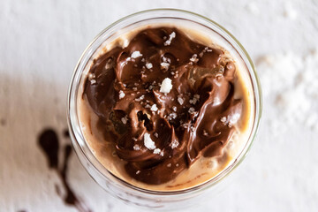 Salted dark chocolate iced coffee on white table on background. Top view.