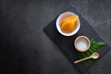 Sweet potato or Yam in syrup usually served coconut milk in vintage zinc coating dish on black...