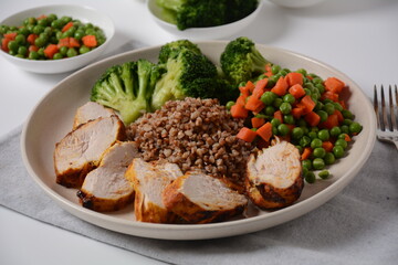 Healthy breakfast. Tasty buckwheat porridge, grilled chicken fillet and vegetables  boiled