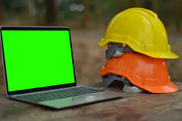 A laptop with a green screen on the table