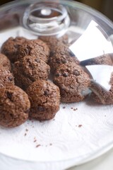 Organic homemade chips cookies with chocolate and cocoa. Close up and blurry view. There is a plastic cover on it. 