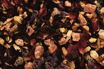 Scattered tea pattern. Many dry flowers background. Lot of dry red petals texture.