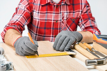Man Taking Measurement For Made Of Furniture. Handyman assembling furniture indoors.