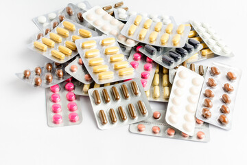 Close up of different medicine pills, tablets and vitamins isolated on white background,...