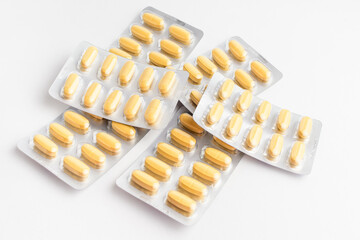 Close up of different medicine pills, tablets and vitamins isolated on white background, pharmaceutical picture taken with soft focus.