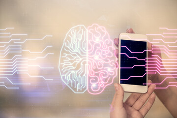 Double exposure of brain sketch hologram and woman holding and using a mobile device.