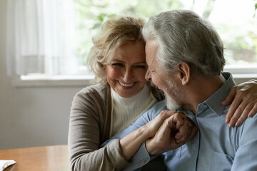 Happy elder family couple laughing and hugging, expressing love and affection. Mature wife and...